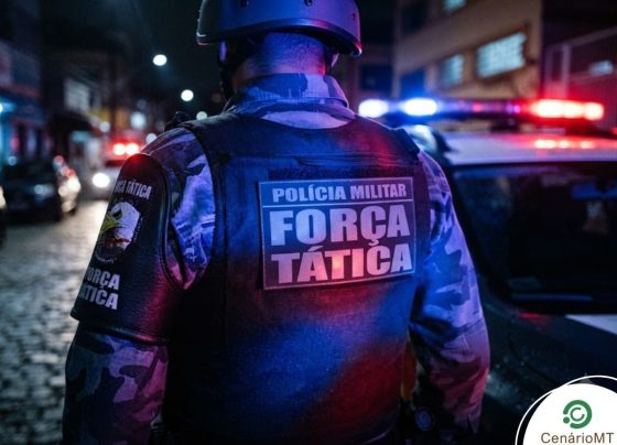 Policial militar da força tática ao lado de viatura